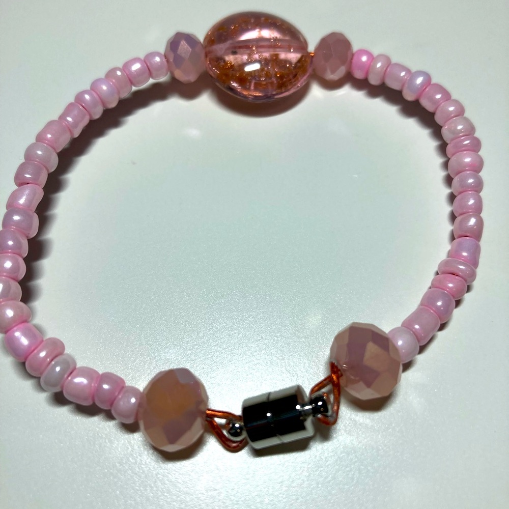 Handmade pink beaded bracelet with glass statement bead, magnetic clasp closure